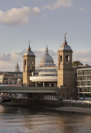 London, UK - Nov 07, 2023 - The Dome of St Paul's Cathedral and the Twin Towers of Cannon Street Railway Station (the City of London) on River Thames with blue sky background. Space for text, Selective Focus.のeditorial素材