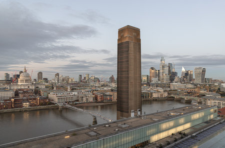 London, UK - Nov 07, 2023 - View of Chimney at Tate Modern art museum, St Paul's cathedral, The skyscrapers with the Millennium Bridge crossing the River Thames with a cityscape of London before sunset. from the viewing platform of Tate Modern's Switch Hoのeditorial素材