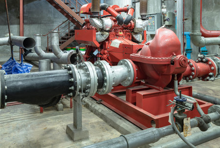 Bangkok,Thailand - 17 Nov, 2024 - Fire protection system of Condominium. Red generator pump for water sprinkler piping and Fire alarm control system, Electric fire pump and Diesel fire pump for Fire fighting system, Copy space, Selective focus.のeditorial素材