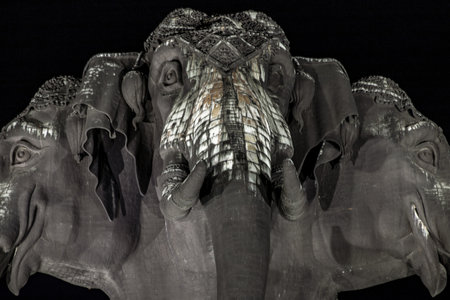 Samut Prakan, Thailand - 13 December 2019 : Close-up of Erawan Museum is a Elephant head sculpture with 3 heads on dark night background, It is one of the important and unique tourist.のeditorial素材