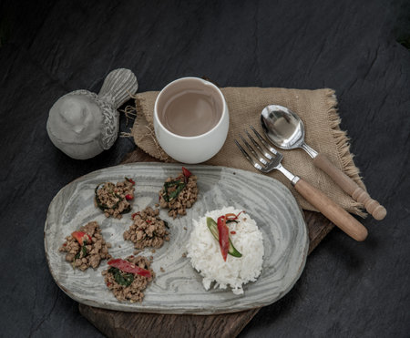 Stir fried Thai basil with minced pork and basil served with steamed rice. Popular traditional food of Thailand. look delicious. Oblique view from the top, Selective focus.の写真素材