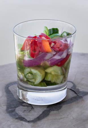 Homemade thai cucumber slices, chili slices and shallots relish slices and vinegar in a glass cup. Ajat, use it as your Wallpaper, Poster and Copy space, Selective focus.の写真素材