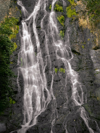 Tropical forest in Sarika waterfall is the landmark national park. Waterfall stream falling down rocks and stones of mountain steep slope at Nakhon Nayok province, Cascade motion, use it as your Wallpaper, Poster and Space for text, Selective focus.の写真素材