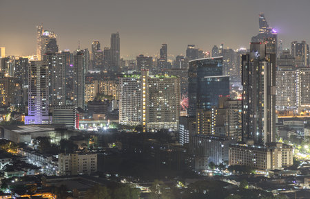 Bangkok, Thailand - 31 Dec, 2024 - Nightscape view after sunset of Skyscrapers in the business district of downtown in the Bangkok city. City night view of Modern buildings after sunset with bright glowing lights, use it as your Wallpaper, Poster and Space for text, Selective focus.の写真素材