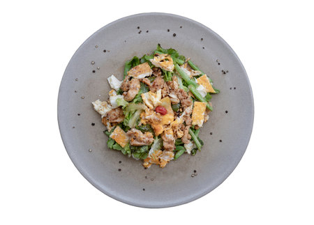 Top view of homemade sliced chicken and fried egg, cherry tomatoes with salad featuring variety fresh green vegetables on round ceramic plate isolated on white background with clipping path. Healthy eating lifestyle concept, use it as your Wallpaper, Poster and Space for text, Selective focus.の写真素材