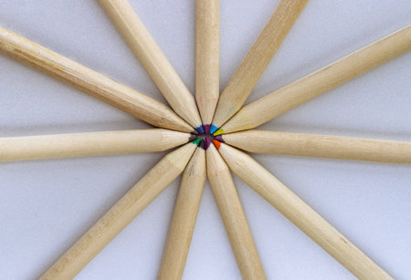 Top view of Brown crayons arranged in a circle on silver background. Wooden colored pencils come together and circle, An artistic display of colored pencils, Stationery for drawing, Minimalism art supplies concept, Empty space for text, design and wallpaper, Selective focus.の写真素材