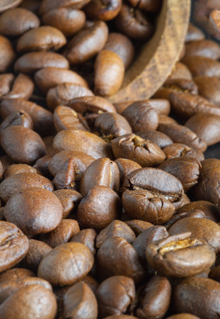 Close-up view of Roasted coffee beans on a rich textured surface. Enjoy your morning coffee for living, use it as your Space for text, Design, Wallpaper and Poster, Selective focus.の写真素材