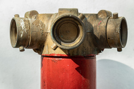 Close up of Red fire hydrant with Brass valve for Fire anticipation on land in front of an on white...
