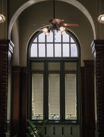 Bangkok, Thailand - Mar 02, 2025 - View of Three wooden louvered window shutters under glass frame...
