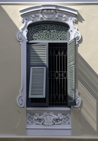 Bangkok, Thailand - Mar 02, 2025 - The Sunlight shines through Wooden louvered window shutters on...