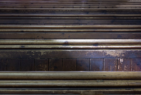 Sunlight filtered through rows of Traditional church benches inside the church. View of The edge of the wooden pews, Selective focus.の写真素材