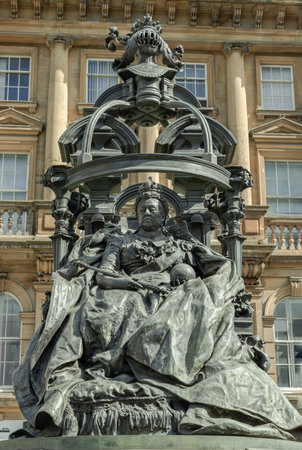 Newcastle, UK - Apr 13, 2025 - Extravagant bronze statue of Queen Victoria in St. Nicholas' Square. The figure of the elderly Queen Victoria is seated on the throne with an elaborate canopy on a Pink granite base is by the sculptor Alfred Gilbert, use it as your Wallpaper, Poster and Copy space, Selective focus.の写真素材