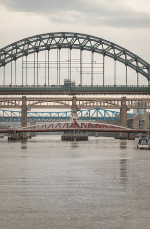 Newcastle, UK - Apr 12, 2025 - Stunning view of the Newcastle upon tyne with Tyne bridge, Swing bridge and The High level bridge spanning the River Tyne connecting Newcastle upon tyne and Gateshead in North East England before sunset. use it as your Wallpaper, Poster and Copy space, Selective focus.の写真素材