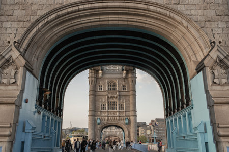 London, UK - Apr 27, 2025 - Crowd of people visit Stunning view of The Iconic Tower Bridge with sky...