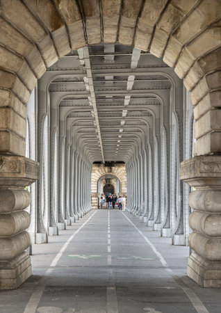 France, Paris - May 03, 2025 - Horizontal perspective view of Stone columns and Steel beams of Steel bridge, Architectural structure of the famous Pont de Bir Hakeim bridge in Paris. use it as your Wallpaper, Poster and Copy space, Selective focus.の写真素材