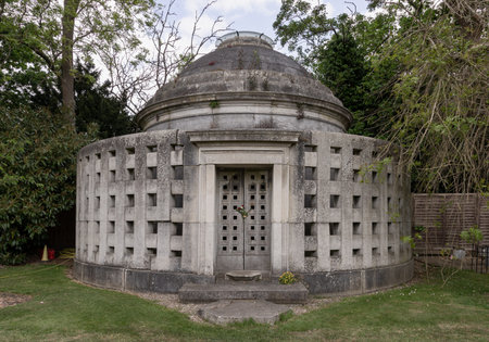 London, UK - May 08, 2025 - The doors are of stone with massive hinges of Phillipson Mausoleum at Golders Green Crematorium and Mausoleum was the first crematorium to be opened at Hoop Lane, in North London, and is one of the oldest crematoria in Britain. use it as your Wallpaper, Poster and Copy space, Selective focus.の写真素材