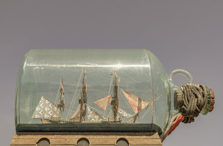 London, UK - Jun 18, 2025 - Nelson's Ship in a Bottle on sky in the background, is a sculpture by the British-Nigerian artist Yinka Shonibare displayed outside the Sammy Ofer Wing of National Maritime Museum in Greenwich. use it as your Wallpaper, Poster and Space for text, Selective focus.の写真素材