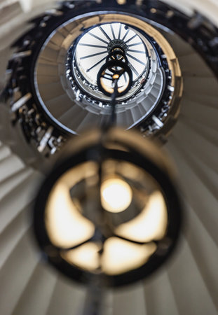 London, UK - Jun 18, 2025 - the spiral staircase located inside The Chapel of St Peter and St Paul at the Old Royal Naval College in Greenwich, This staircase provides access to the upper levels and dome area of the chapel, a glorious view of the spiral stairs leading to the upper levels, use it as your Wallpaper, Poster and Copy space, Selective focus.の写真素材