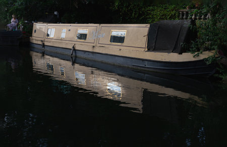 London, UK - Jun 21, 2025 - a picturesque area of Little Venice in West London, It is the junction point of the Grand Union Canal and the Regent's Canal, its tranquil canals and waterways lined with narrowboats and houseboats. use it as your Wallpaper, Poster and Space for text, Selective focus.の写真素材