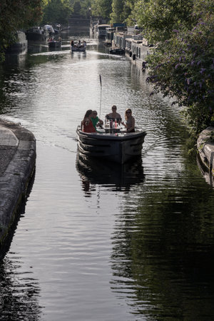 Tourist are relaxing on a Waterdream boat in Little Venice in West London at evening, It is the junction point of the Grand Union Canal and the Regent's, its tranquil canals and waterways lined with narrowboats and houseboats. use it as your Wallpaper, Poster and Copy space, Selective focus.の写真素材