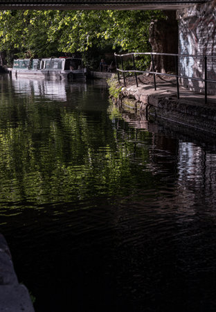 London, UK - Jun 21, 2025 - a picturesque area of Little Venice in West London, It is the junction point of the Grand Union Canal and the Regent's Canal, its tranquil canals and waterways lined with narrowboats and houseboats. use it as your Wallpaper, Poster and Space for text, Selective focus.の写真素材