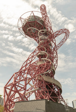 London, UK - Jun 21, 2025 - A stunning sculpture of ArcelorMittal Orbit and features Red lattice structure with a Spiral slide, known as the Helix, Observation tower located in Queen Elizabeth Olympic Park in Stratford, use it as your Wallpaper, Poster and Space for text, Selective focus.の写真素材