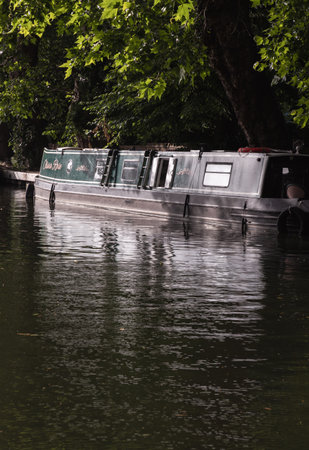 London, UK - Jun 21, 2025 - a picturesque area of Little Venice in West London, It is the junction point of the Grand Union Canal and the Regent's Canal, its tranquil canals and waterways lined with narrowboats and houseboats. use it as your Wallpaper, Poster and Space for text, Selective focus.の写真素材