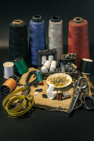 Steel scissors, Spools of thread of various colors, Thimbles in small wooden treasure chest, Sewing...