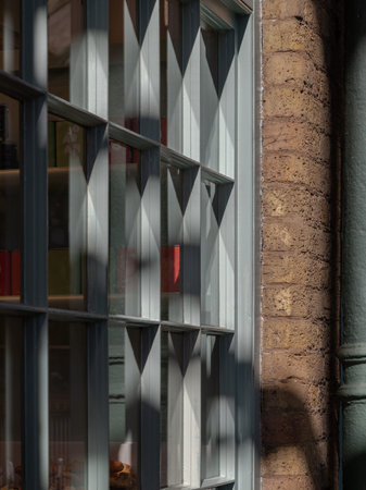 Sunlight streams through bakery shop glass window display. Sunbeam filtered shining through glass...