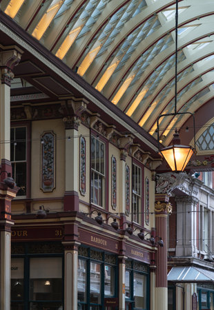 London, UK - Jul 27, 2025 - The spectacular victorian architecture of Leadenhall Market is housed beneath, is a combination of ornate wrought-iron, glass roof allowing natural light to illuminate the market space. use it as your Wallpaper, Poster and Sapce for text, Selective focus.の写真素材