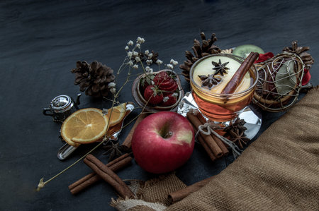 Glass of freshly brewed fruit and herbal tea. Darker background.