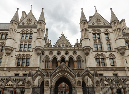 London, UK - Jul 27, 2025 - Victorian Gothic Revival architecture of the Royal Courts of Justice on the Strand, Serves as the center for many important court hearings in the United Kingdom, use it as your Wallpaper, Poster and Copy space, Selective focus.の写真素材