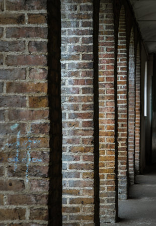 London, UK - Apr 27, 2025 - Perspective of Red brick columns an Historic Building. Several dark...