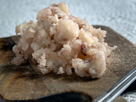 Close-up of Delicious Crispy And Crunchy Deep-Fried Calamari or Crispy Deep-Fried Squid and Silver chopsticks served on Wooden cutting board, use it as your Wallpaper, Poster and Space for text, Selective focus.の写真素材