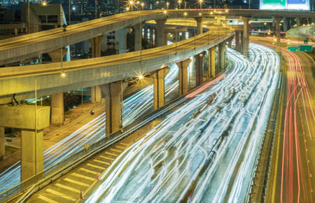 Bangkok, Thailand - Jan 10, 2025 - A nightscape view with bright glowing light trails effect of many...