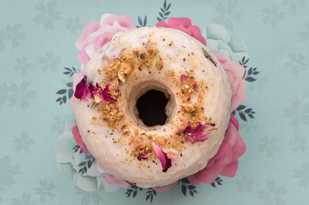 Pistachio & Rose Baked Doughnuts featuring a white glaze generously decorated with crushed...