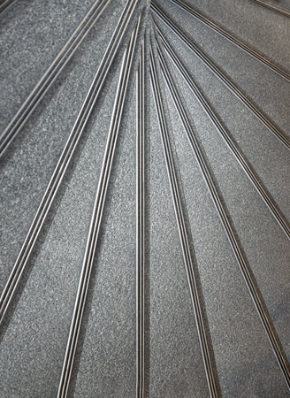The geometric shape of the staircase winds in a spiral pattern. Looking down view of helix stairs,...