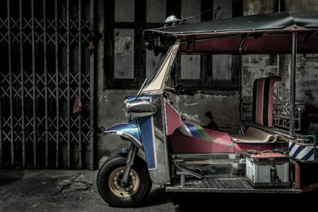 Bangkok, Thailand - Dec 7, 2019 : Famous blue Tuk Tuk, The front of thai traditional taxi with an old ancient wall behind.のeditorial素材