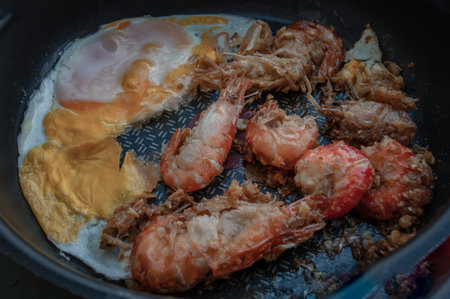 Tasty appetizing garlic Prawns, Shrimps on frying pan with Fried eggs in a frying. Top View with Copy space. Food Background Kitchen Conceptの写真素材