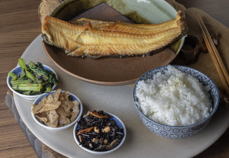 A traditional Japanese teishoku set meal features a large, golden-brown charcoal-grilled Atka...