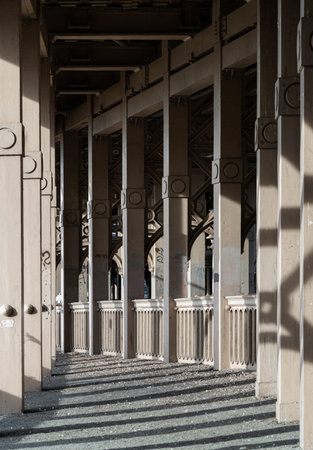 Newcastle, UK - Apr 11, 2025 - Light and shadow dance across the concrete walkway, framed by a...