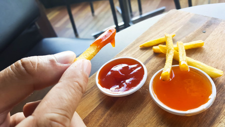 French fries with ketchup on woodenの写真素材