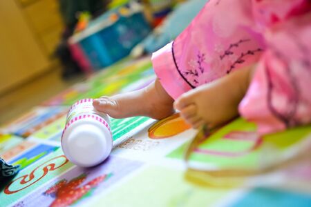 One year old old baby hands and feet closeupの写真素材