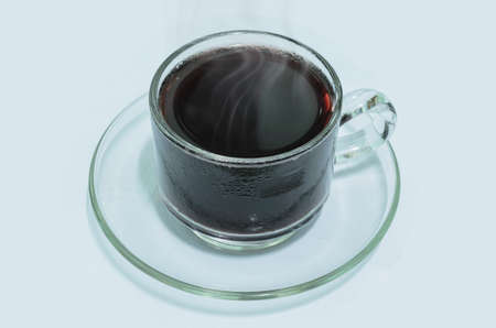 Cold lemon tea with smoke in glass on white background.の写真素材