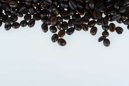Coffee beans handful closeup isolated on white backgroundの写真素材
