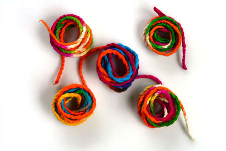Mixed pile of colorful yarn on white backgroundの写真素材