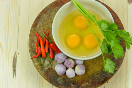 Ingredients for making omelets on wooden backgroundの写真素材