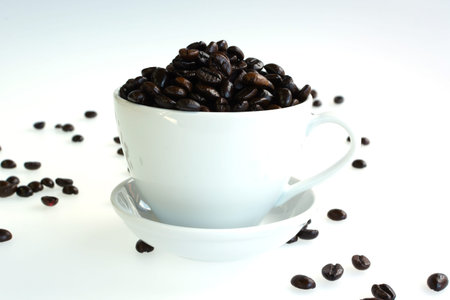 cup with coffee beans isolated on white background