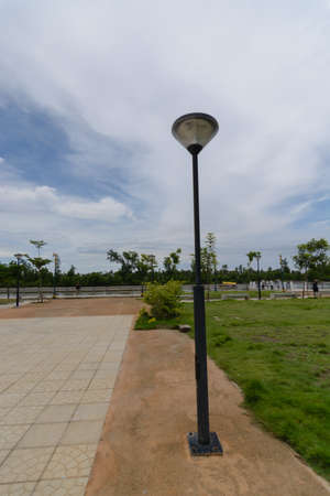 electric pole with blue sky and white clouds behind in the park electric pole with blue sky and white clouds behind in the park