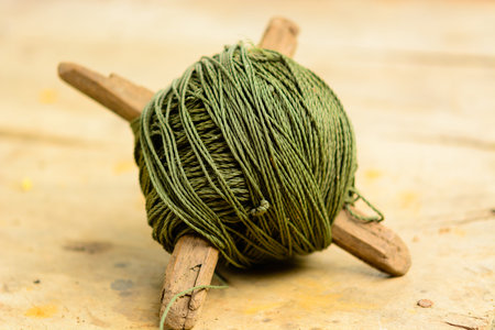 Roll of green nylon rope on wooden background